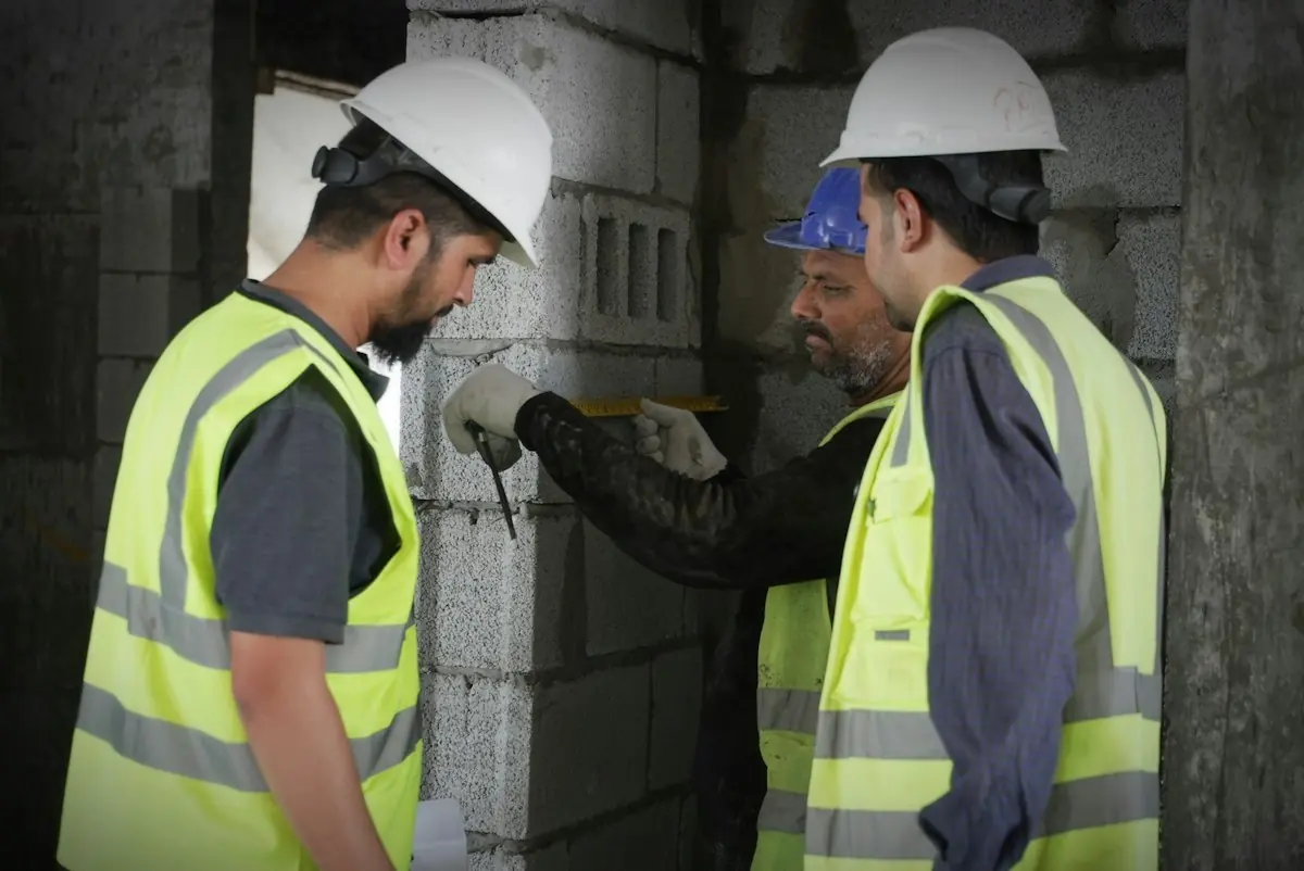 Two engineers in safety vests working on site