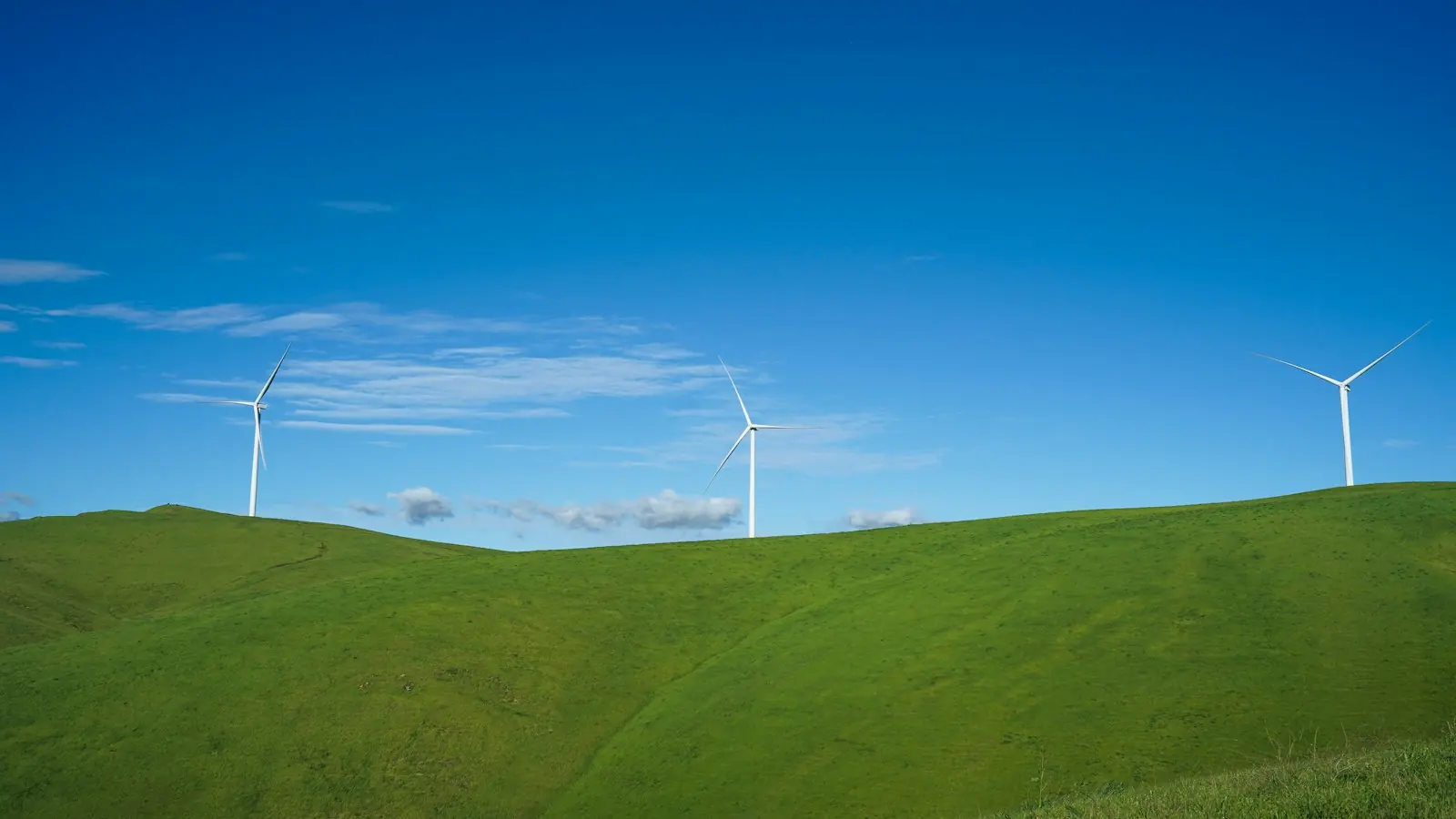 Wind turbines on green rolling hills