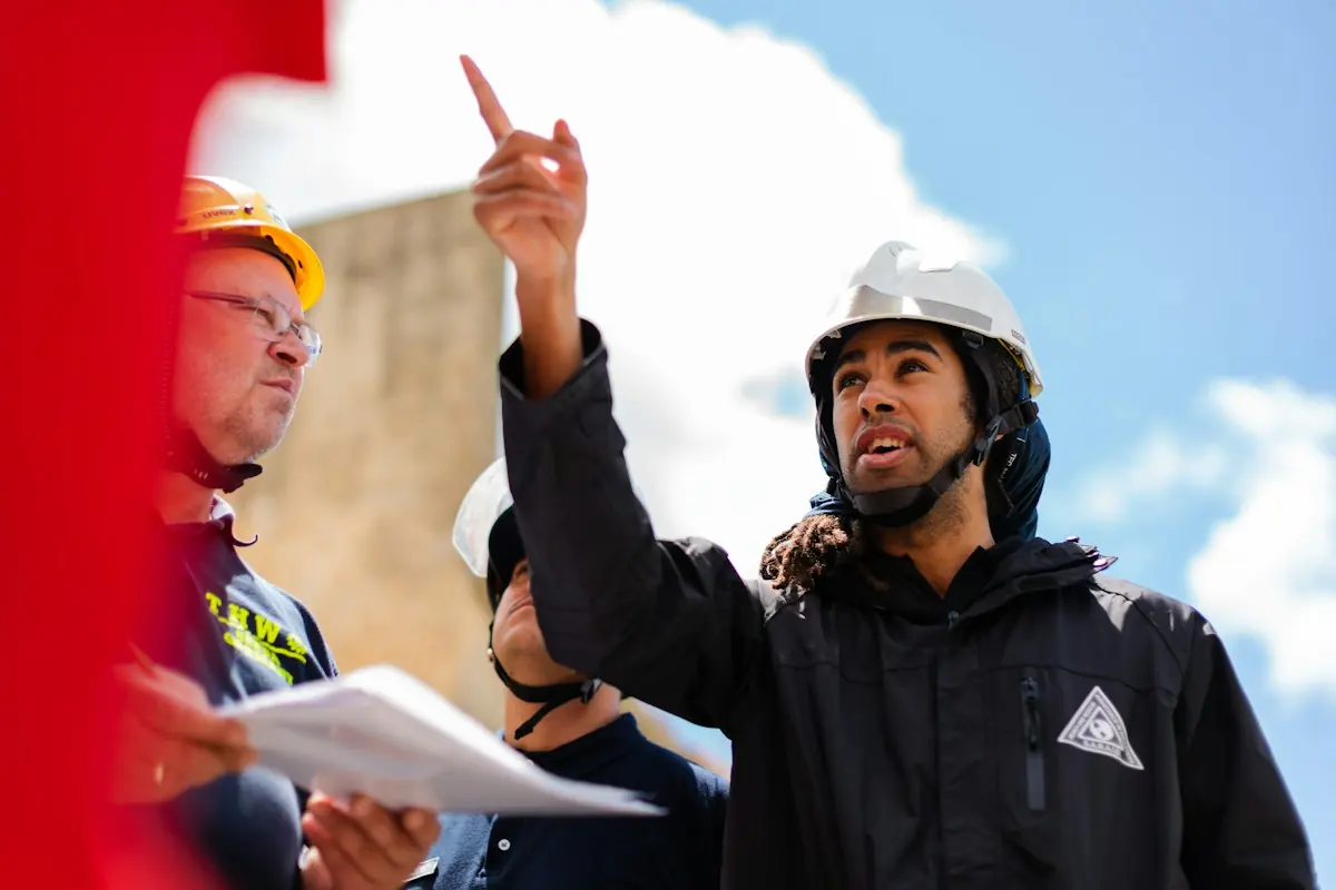 Engineer pointing at a site while a colleague takes notes